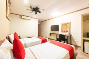 Postel nebo postele na pokoji v ubytování DG Grami Hotel