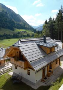an overhead view of a house with a metal roof at Bergdorf Riesner in Donnersbachwald