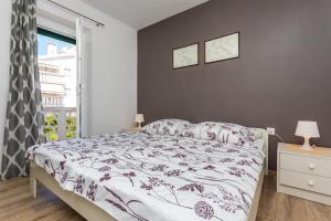 a bedroom with a bed and a window at Apartments Marija in Baška