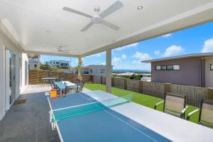 a blue ping pong table on the patio of a house at Modern Luxury Ocean Views in Townsville
