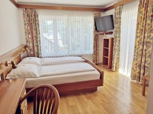 Een bed of bedden in een kamer bij Hotel Auszeit