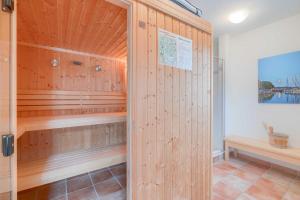 a sauna with wood paneling and a wooden wall at Strandhaus Thiessow Whg_ 3 in Thiessow