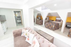 a living room with a couch and a bed in a room at The Breeze Hotel in Eskisehir