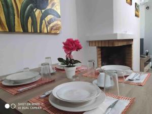 a dining room table with plates and a fireplace at "Athena 3" luxury's apartments in Athens !!! in Athens
