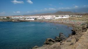 a group of people swimming in the water at a beach at La Casa del Sol, Abades in Abades
