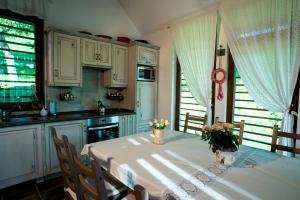 a kitchen with a table with flowers on it at Fruktárium vendégház in Trizs