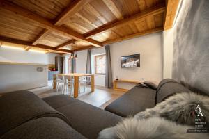 a living room with a couch and a table at Alp Apartments SKI & BIKE - Tourneuve5 in Aosta
