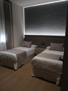 A bed or beds in a room at Aljibe Casa Rural