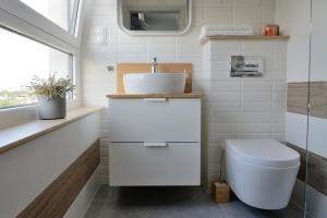 a bathroom with a sink and a toilet at Bułgarska 59A- (1/2) piękny widok 14 piętro in Poznań +34 photos