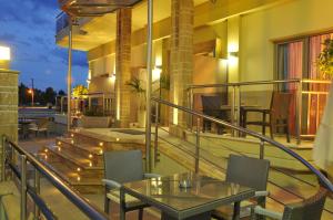 a balcony with a table and chairs on a building at Hotel Epavlis Eleftheriadi in Paralia Katerinis