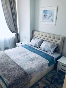 a bedroom with a large bed and a window at White apartments in Arcadia in Odesa