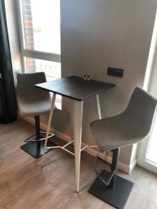 a table and two chairs in a room at Butas centre in Klaipėda