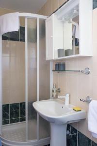 a bathroom with a sink and a shower at Rooms Stolfa in Krk