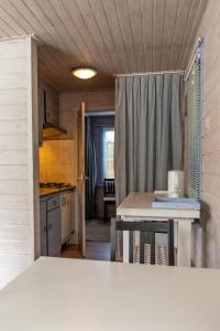 a small kitchen with a table and a counter top at Vakantiehuis Duin Bos en Zee in Schoorl