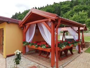 a gazebo with flowers on it at Domino in Korytné