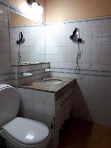 a bathroom with a white toilet and a sink at Cabañas Inti Killa (MR) in Cachí