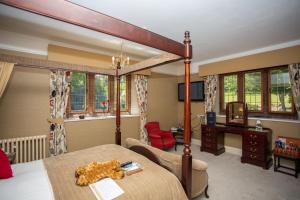 a bedroom with a bed and a desk in a room at Dales Country House Hotel in Sheringham