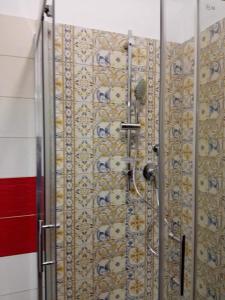 a shower stall in a bathroom with a curtain at B&B Da Nonna Rita in Bagnara Calabra