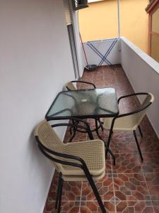 two chairs and a table on a balcony at Guesthouse Marko in Becici