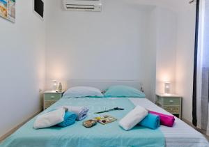 a bed with a blue comforter and pillows on it at VILLA STELLA JURICANI in Umag +48 photos