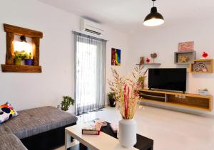 a living room with a couch and a tv at VILLA STELLA JURICANI in Umag