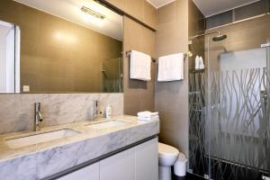 a bathroom with two sinks and a mirror at InkaHuset Miraflores Oceanfront in Lima +37 photos
