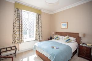 a bedroom with a large bed and a window at Sea Marge Hotel in Overstrand