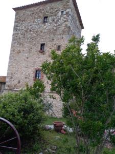 a large brick building with two windows on it at Castello di Casallia in Vetulonia