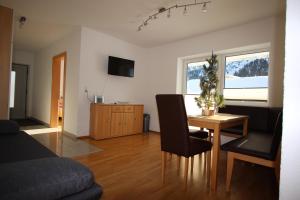 a living room with a table and a couch at Ferienhaus Lena in Oetz