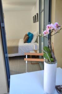 a view of a bedroom with a bed and a mirror at Le Clos des Salins in Toulouse