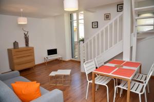 a living room with a couch and a table at Le Clos des Salins in Toulouse