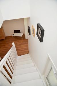 a white staircase in a room with a laptop on the wall at Le Clos des Salins in Toulouse