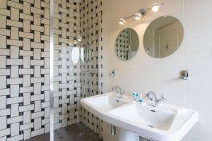 a bathroom with a sink and a mirror at Hôtel Restaurant Gastronomique La Huchette in Mâcon +62 photos