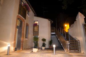 a building with two potted plants in front of it at Le Clos des Salins in Toulouse