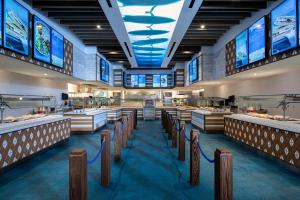 a fast food restaurant with rows of counters and televisions at Universal's Endless Summer Resort - Surfside Inn and Suites in Orlando