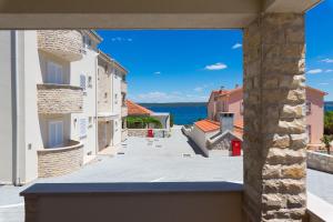 a view from the balcony of a house at OrkulaBliss Apartments in Pašman