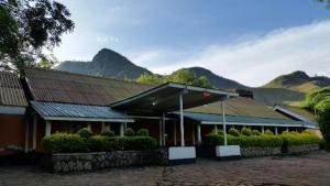 a building with mountains in the background with at Mt Moroto Hotel in Moroto