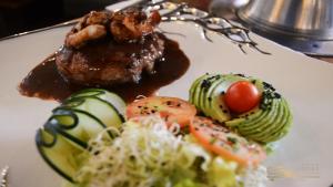 a plate of food with meat and vegetables on it at Hotel San Marcos Grand in Culiacán