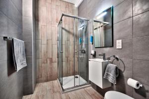 a bathroom with a shower and a sink at Cozy Rooms Hotel in Sliema
