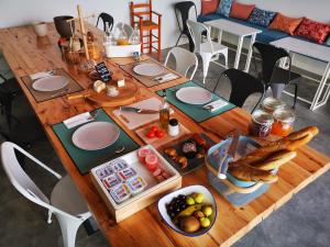 a wooden table with plates and food on it at Can Liret in Palafrugell