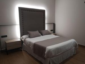 A bed or beds in a room at Aljibe Casa Rural