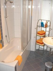 a bathroom with a shower and a tub and a sink at Appartement Granbichler Siegfried in Längenfeld