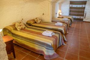 A bed or beds in a room at Cuevas el Torriblanco