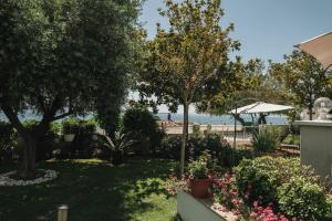 a garden with a view of the beach at Apartments Lucija in Zadar