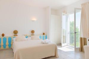 a white and blue bedroom with a bed and a window at B&B Casale Savini in Ortona