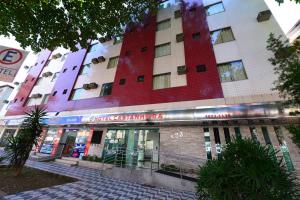 a building with a red and white building at Hotel Castanheira in Ipatinga