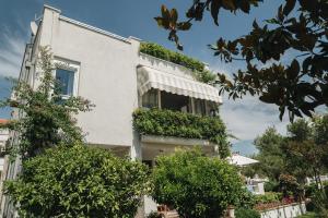 a building with plants on the side of it at Apartments Lucija in Zadar