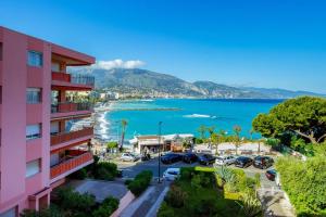 a pink apartment building with a view of the ocean at Terrazza Vista Mare, Parcheggio, Aria condizionata in Roquebrune-Cap-Martin