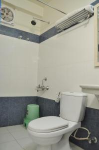 a bathroom with a white toilet and a fan at Hotel Savoy - Since 1951 in Jaipur +28 photos