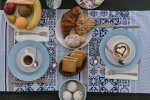 a table with plates of breakfast foods and a cup of coffee at Stazione a mare in Casalbordino
